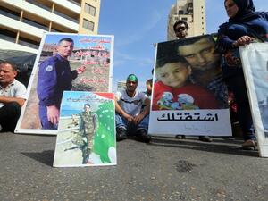 Relatives of Lebanese soldiers and policemen being held hostage by jihadists in Syria, hold portraits during a protest to press for their release. (AFP/Joseph Eid)
