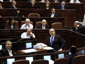Israeli Prime Minister Benjamin Netanyahu (center-right) and Defense Minister Ehud Barak (left) during the session of the Knesset in Jerusalem. (AFP/File)
