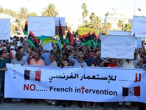 Libyan protesters hold banners and placards during a demonstration in the capital, Tripoli, to protest the French military intervention in the North African country, July 20, 2016. (AFP/File)