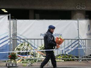 A security official lays flowers at the memorial site at Maalbek metro station. (AFP/File)