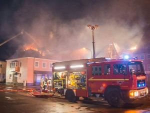 Fire fighters try to extinguish a fire at a former hotel that was under reconstruction to become a home for asylum seekers on February 21, 2016 in Bautzen east of Dresden, eastern Germany. (AFP/Rico Loeb)
