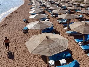 A tourist walks past empty sunbeds on a beach in Egypt. (AFP/File)