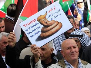 The activity included hanging up pictures of Trump with slogans rejecting his views which many have called divisive and racist. As activists began burning images of Trump, Israeli forces quickly arrived and attempted to expel them from the area, while threatening to use force on the activists. (AFP/File)