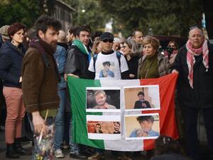 Protesters hold an Italian flag covered with photos of murdered Italian student Giulio Regeni. (AFP/File) 