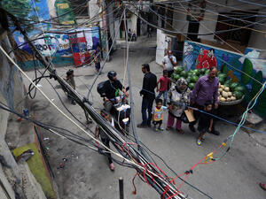 In this May 21, 2014 photo, Palestinian refugees walk under electricity cables in an alley in the Palestinian refugee camp of Shatila in Beirut, Lebanon. (AFP/Bilal Hussein)