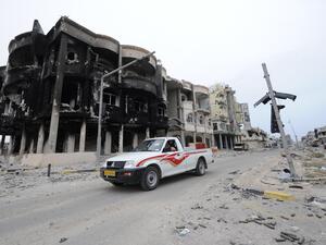 Libyans drive through a destroyed neighborhood in Sirte in 2011. (AFP/File) Libyans drive through a destroyed neighborhood in Sirte in 2011. (AFP/File)