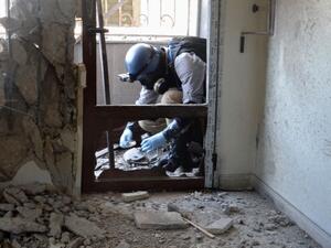 A United Nations weapons expert collects samples during an investigation into a 2013 suspected chemical weapons. (AFP/File)
