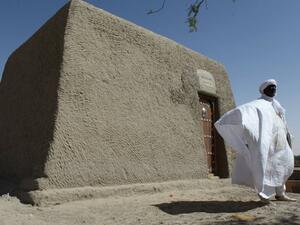 Sane Chirfi, representing the family that looks after the Alpha Moya mausoleum, poses in front of the recovered monument on February 4, 2016. (AFP/Sébastien Rieussec)