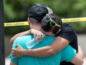 A man weeps at the scene of the Pulse nightclub shooting in Orlando (Gregg Newton/AFP)