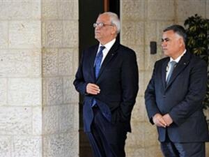 Chief Palesinian negotiator Saeeb Erakat (L) and one of his deputy wait for US Secretary of State John Kerry before his meeting with Palestinian President Mahmud Abbas on July 19, 2013 at the Mukataa compound, in the West Bank city of Ramallah. Kerry flew by helicopter to the West Bank from Jordan to meet Abbas as he battled to salvage his Middle East peace bid.( FADI AROURI/AFP/Getty Images)