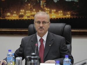 Palestinian Prime Minister Rami Hamdallah chairs the first working meeting of the new Palestinian government in the West Bank town of Ramallah on June 11 (Abbas Momani / AFP)