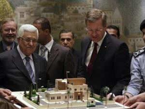 عباس (يسار) والرئيس الالماني يستعرضان مجسما لمركز شرطة تمول المانيا اقامته خلال لقائهما في رام الله