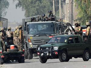 Soldiers arrive to take position outside a Pakistan Air Force (PAF) base after an attack by militants in Peshawar on September 18, 2015. (AFP)