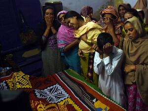 Pakistani relatives mourn over the coffin of a 13-year-old blast victim Zeeshan during his funeral on February 17, 2017, after a bomb blew up in the shrine of 13th century Muslim Sufi saint Lal Shahbaz Qalandar. (AFP/Asif Hassan)