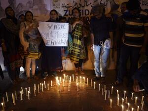 Pakistani activists and mourners light candles during a vigil in Karachi on February 17, 2017, to pay tribute to the victims of a bomb attack on a Sufi Muslim shrine. (AFP/Rizwan Tabassum)