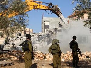 جنود اسرائيليون يحرسون جرافة تقوم بهدم منزل فلسطيني في قرية حارس بالقرب من مدينة نابلس/أ.ف.ب