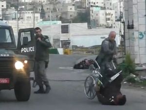 Palestinian man is knocked out of his wheelchair (Facebook / Raed Abu Rumaila)