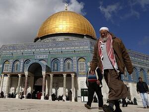 A Palestinian man walks past Al-Aqsa Mosque compound before the Friday prayer in Jerusalem's Old City on January 13, 2017. (AFP/Ahmad Gharabli)