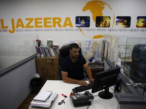Employees of Qatar based news network and TV channel Al-Jazeera are seen at their Jerusalem office on July 31, 2017 (AFP)