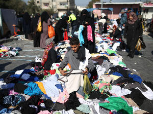 Palestinians sifts through used clothes and items at the weekly flea market in the Nusseirat refugee camp, central Gaza Strip, on February 29, 2016. (AFP)