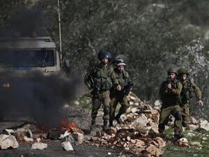 Israeli soldiers keep position during clashes with Palestinian protestors following a weekly demonstration against the expropriation of Palestinian land by Israel in the village of Kfar Qaddum, near Nablus, in the occupied West Bank on February 10, 2017. (AFP/Jaafar Ashtiyeh)