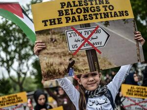 A young girl holds placard reading "Al Quds belongs to Muslims" on May 11, 2018 in Istanbul, during a demonstration against US President Donald Trump’s controversial decision to recognise Jerusalem as Israel’s capital by opening a US embassy there. (AFP/ File Photo)