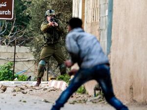 A Palestinian protester confronts an Israeli soldier during an army search operation in the village of Burqa. (AFP/ File Photo)