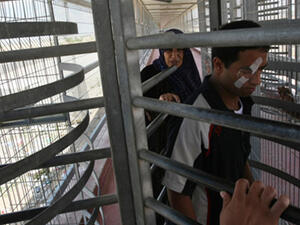 Palestinians walk through the Erez border crossing with Israel in the northern Gaza Strip as they cross into Gaza, on June 09, 2010. (AFP/Mahmud Hams)