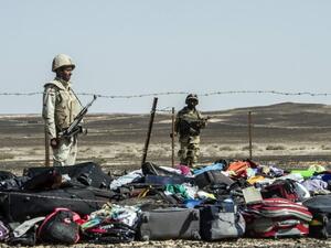 Egyptian army soldiers guard luggage and belongings of passengers of the A321 Russian airliner, at the site of the crash in Wadi al-Zolomat. (AFP/Khaled Desouki)