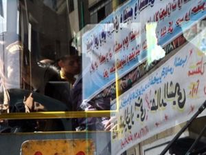 An Egyptian passenger is seen through electoral banners reflected on the windscreen of a public bus in al-Sayyida Zaian district, in downtown Cairo, on November 23, 2010, as the campaign rally for the upcoming November 28, Egyptian general election continues