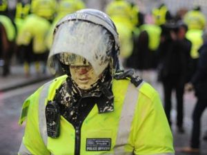 A British riot policeman is covered in paint during student demonstrations in London, on December 9, 2010. Angry demonstrators clashed with police in a student protest outside parliament Thursday as the coalition government faced its biggest test yet in a vote on proposals to triple university tuition fees