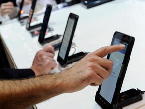 Convention attendees use Samsung Galaxy Tab Android tablets at the 2011 International Consumer Electronics Show at the Las Vegas Convention Center January 6, 2011