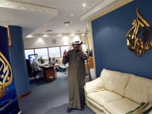 Al-Jazeera's bureau chief in Kuwait Saad al-Saedi talks on his mobile phone at the channel's office in Kuwait City on December 13, 2010