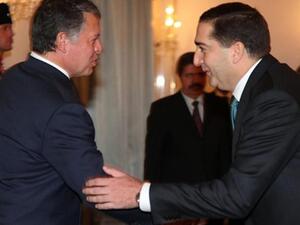 Jordan's Prime Minister Samir Rifai (R) shaking hands with Jordan's King Abdullah after taking the oath of office in Amman on November 24, 2010. King Abdullah once described Jordan as between "Iraq and a hard place."