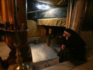 A nun prays at the Church of the Nativity, believed to be the birthplace of Jesus Christ, in the West Bank town of Bethlehem on December 24, 2010 as the Holy Land prepares to mark Christmas