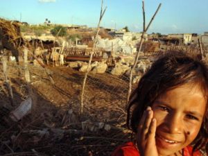 A young Palestinian girl stands in front of her Bedouin tent slum, in the seaside al-Mawasi area.