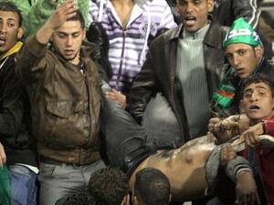 Jordanians carry a football fan injured during clashes following the Jordanian professional league football match between Al-Wihdat and Al-Faisali in east Amman on December 10, 2010