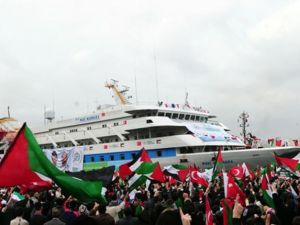 People wave Palestinian and Turkish flags as they welcome the Mavi Marmara ship at Istanbul's Sarayburnu port on December 26, 2010. The Turkish ferry which was the target of a deadly raid by Israeli commandos when it tried to deliver aid to Gaza received a rapturous welcome from thousands on Sunday as it arrived back in Istanbul. 