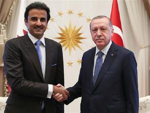 This handout photo taken and released by the Turkish presidential press service on August 15, 2018 shows Turkey's President Recep Tayyip Erdogan (R) and the Emir of Qatar Sheikh Tamim bin Hamad Al-Thani shaking hands prior to their talks in Ankara. (AFP)