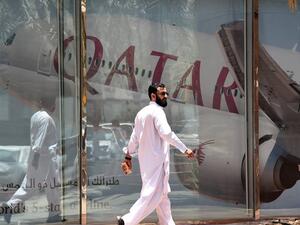 A picture taken on June 5, 2017 shows a man walking past the Qatar Airways branch in the Saudi capital Riyadh, after it had suspended all flights to Saudi Arabia following a severing of relations between major gulf states and gas-rich Qatar. Arab nations including Saudi Arabia and Egypt cut ties with Qatar accusing it of supporting extremism, in the biggest diplomatic crisis to hit the region in years.
FAYEZ NURELDINE / AFP