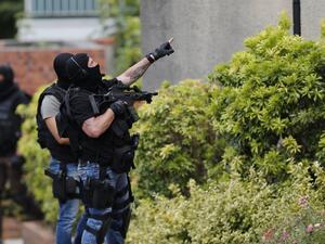 French policemen search house-by-house in Saint-Etienne-du-Rouvray after attackers killed a priest at a church in the village. (AFP/Charly Triballeau) French policemen search house-by-house in Saint-Etienne-du-Rouvray after attackers killed a priest at a church in the village. (AFP/Charly Triballeau)