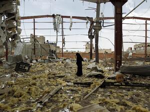 A Yemeni woman inspects the rubble of a factory allegedly targeted by Saudi-led airstrikes in the Yemeni capital Sanaa. (AFP/Mohammed Huwais)
