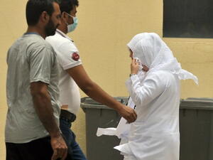 Saudi nurses and citizens walk outside the King Fahad hospital in the city of Hofuf, some 370 kilometres East of the capital Riyadh, on June 16, 2013. (FAYEZ NURELDINE/AFP/Getty Images)