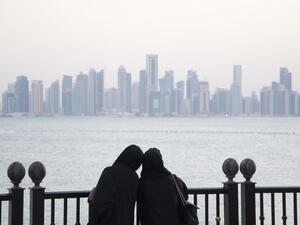 Two girls look out at the Doha skyline. Qatar's hydrocarbon growth is not what it used to be. But its non-oil growth has shot to over 10 percent (Albawaba/J. Zach Hollo)