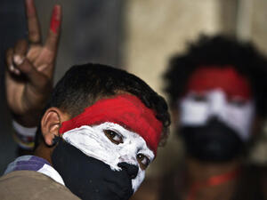 Egyptian youth with their faces painted in the colours of the national flag look on as opponents of Egyptian President Mohamed Morsi protest calling for his ouster at Cairo's landmark Tahrir Square (Source: AFP/KHALED DESOUKI)