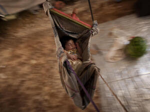 A Syrian refugee baby sleeps in a hammock at the Bab al-Salam refugee camp in Syria's northern city of Azaz on July 15, 2013. (Source: AFP/JM LOPEZ)
