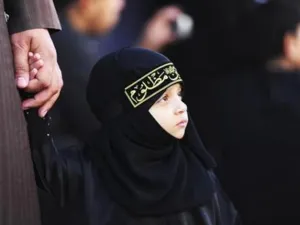 طفلة تصحب والدها الشيعي خلال احتفالات عاشوراء في مدينة القطيف بشرق السعودية 