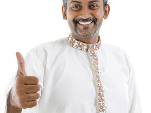 Excited thumb up Indian man in traditional costume kurta dhoti (Shutterstock/szefei)