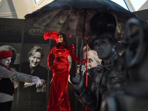 A woman poses for photographs at an invitation-only screening of Black Panther.
(Fayez Nureldine / AFP Photo)