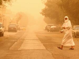 A Saudi man crosses street in Riyadh in a 2012 sandstorm that hit the city. (AFP/ File Photo)